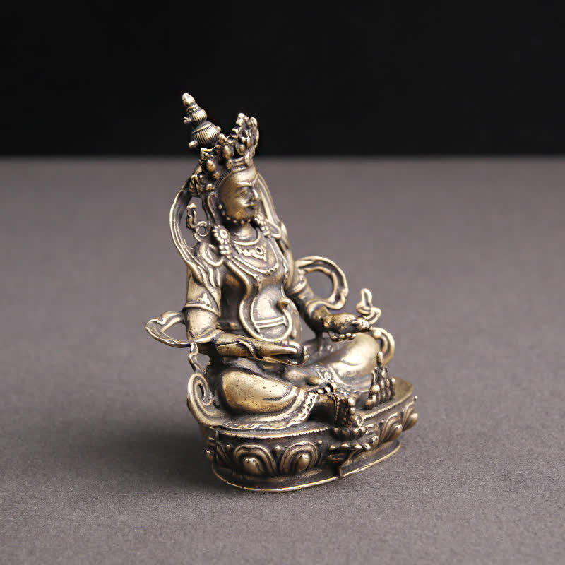 Yellow Jambhala Copper Buddha Statue – back view showing fabric texture, outdoor prayer textile