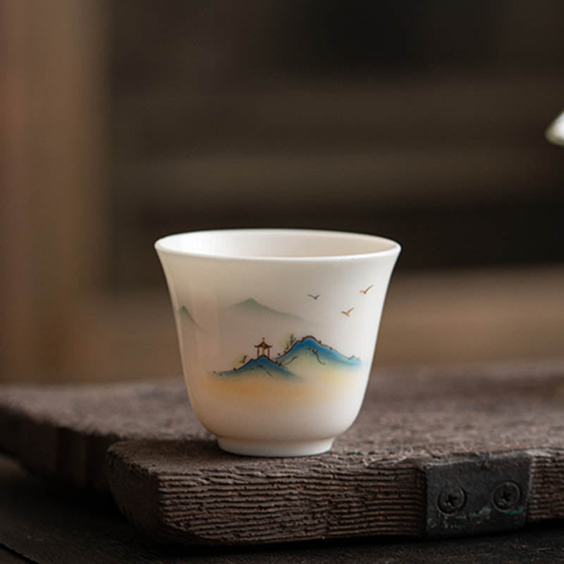 Ceramic Kung Fu Tea Cup – misty mountain peaks with small pavilion and flying birds in layered blue tones, contemplative
