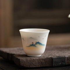 Ceramic Kung Fu Tea Cup – misty mountain peaks with small pavilion and flying birds in layered blue tones, contemplative