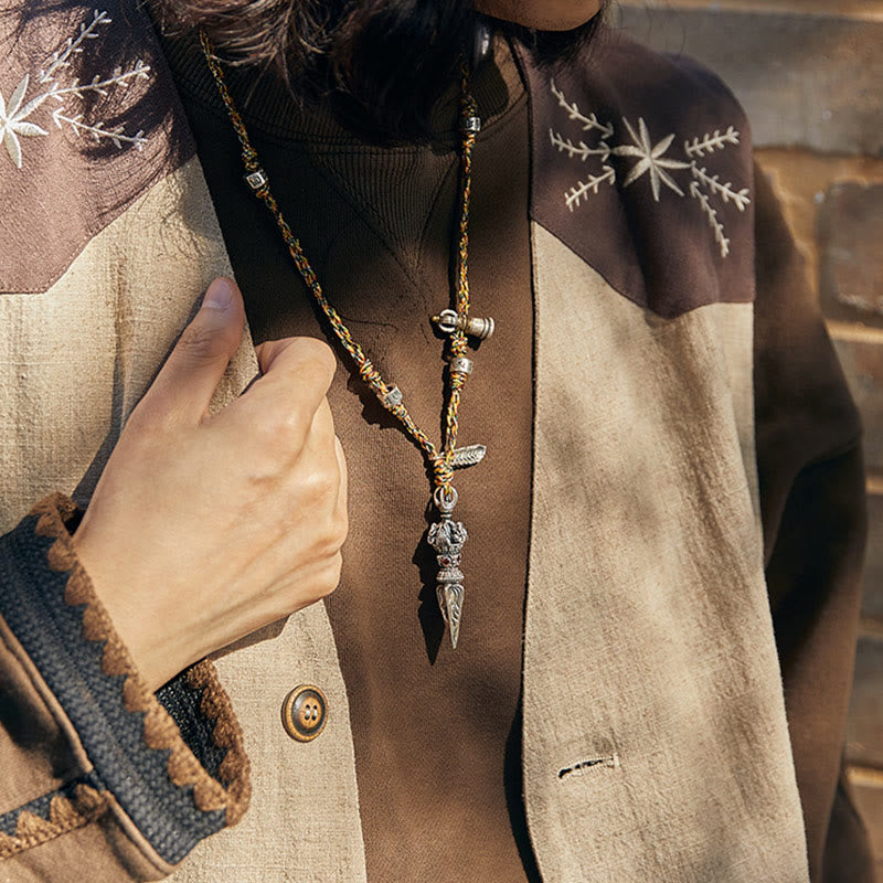 Dorje Vajra Pendant – Worn with hand on lapel showing dagger detail, Himalayan spiritual jewelry