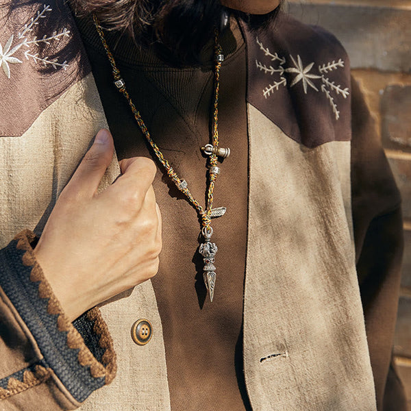 Dorje Vajra Pendant – Worn with hand on lapel showing dagger detail, Himalayan spiritual jewelry