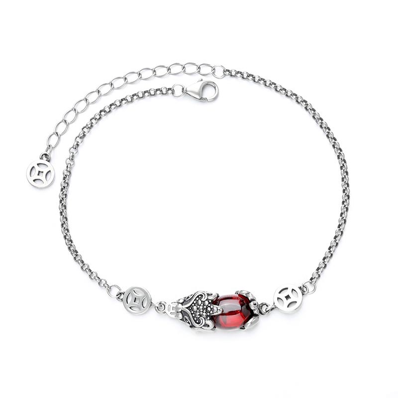 Copper Garnet PiXiu Wealth Bracelet – Flat lay of silver chain bracelet with red garnet PiXiu on white