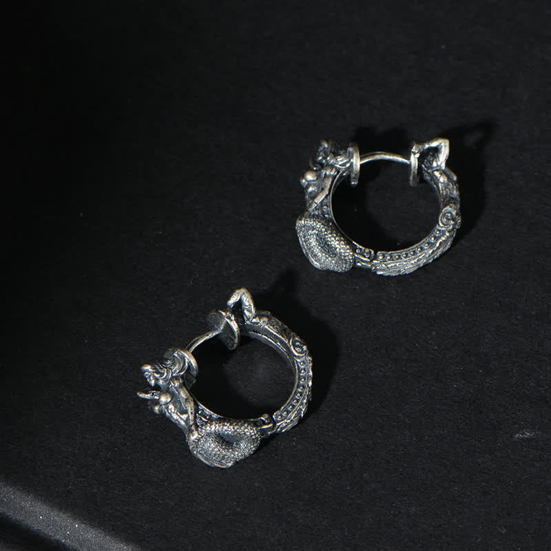 Sterling Silver Dragon Hoop Earrings – coiled dragon serpent hoops on matte black fabric, intricate scale carving, gothic