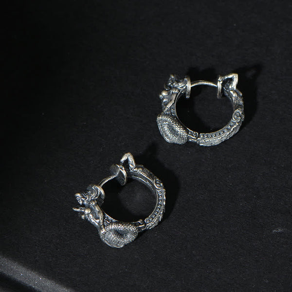 Sterling Silver Dragon Hoop Earrings – coiled dragon serpent hoops on matte black fabric, intricate scale carving, gothic