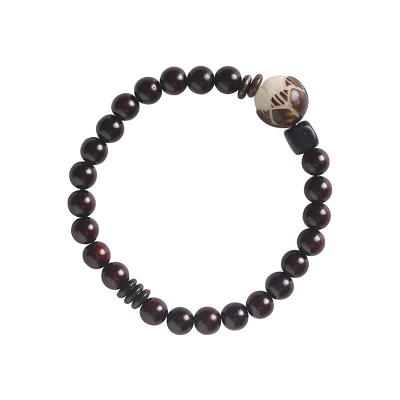 Red Sandalwood Lotus Bodhi Seed Bracelet – Dark wood beads with etched focal bead on white background, e-commerce flat lay