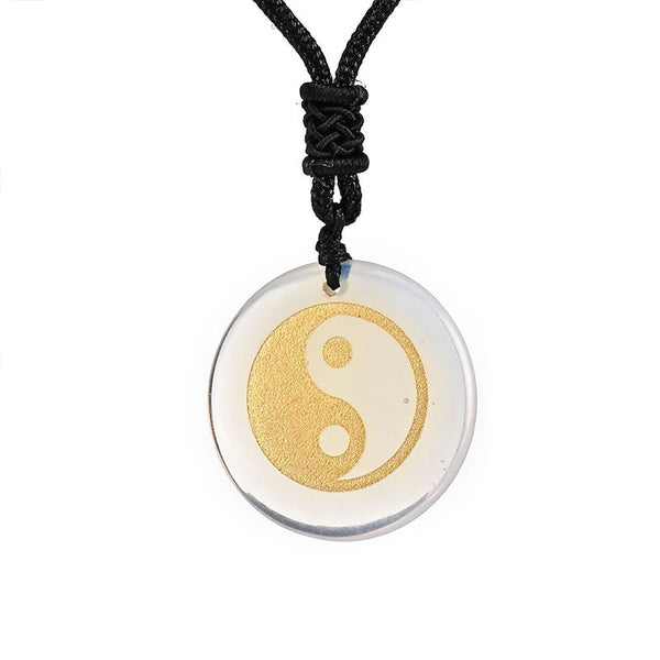 Yin Yang Crystal Necklace – Clear quartz round pendant with gold yin-yang symbol on black cord, transparent polished stone, m