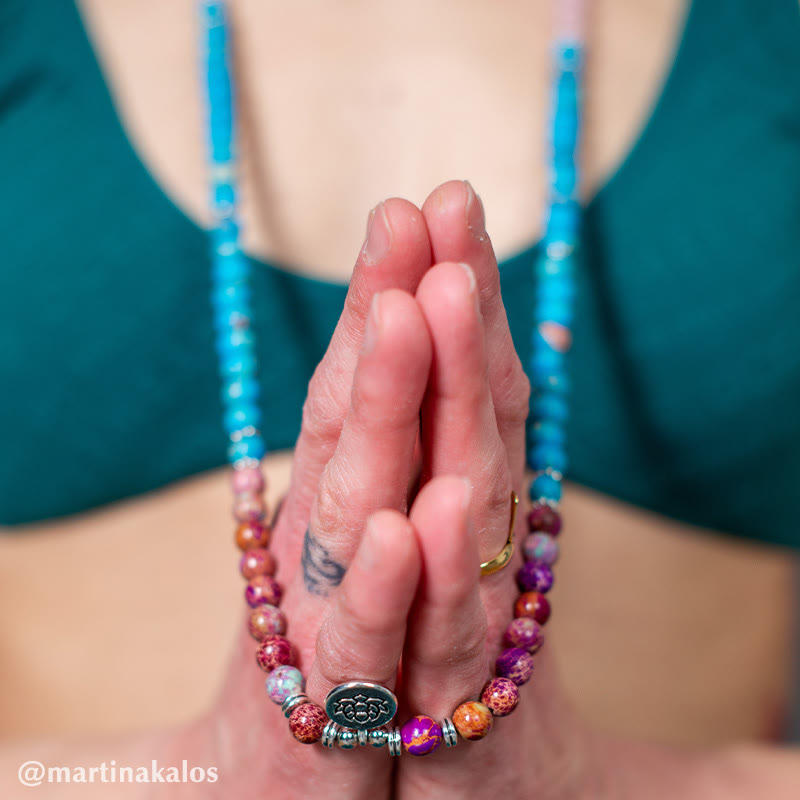 Tibetan Purple Miano Bead Lotus Mala - purple beads with lotus charm on praying hands, spiritual bracelet