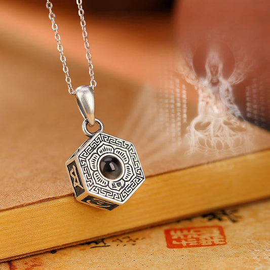 Om Mani Padme Hum Lotus Projection Necklace – Hexagonal sterling silver pendant with dark stone on aged book, spiritual je...