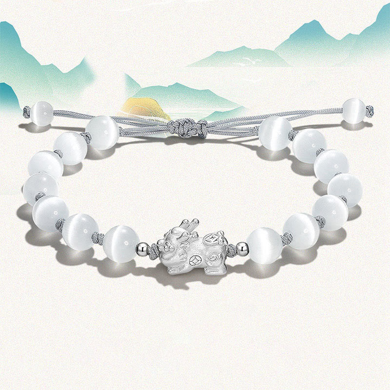 Cat's Eye PiXiu Bracelet – White cat's eye bracelet with silver charm, mountain backdrop