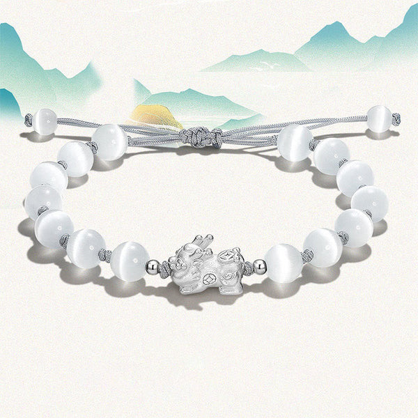 Cat's Eye PiXiu Bracelet – White cat's eye bracelet with silver charm, mountain backdrop