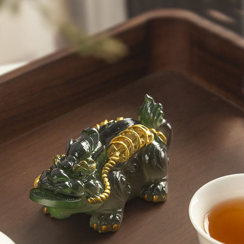 PiXiu Coin Tea Pet – Dark green PiXiu on wooden tray beside white tea cup, tea table decor