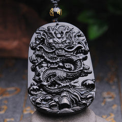 Black Obsidian Dragon Pendant – Dragon carving with gold mantra bead on stone pedestal, spiritual