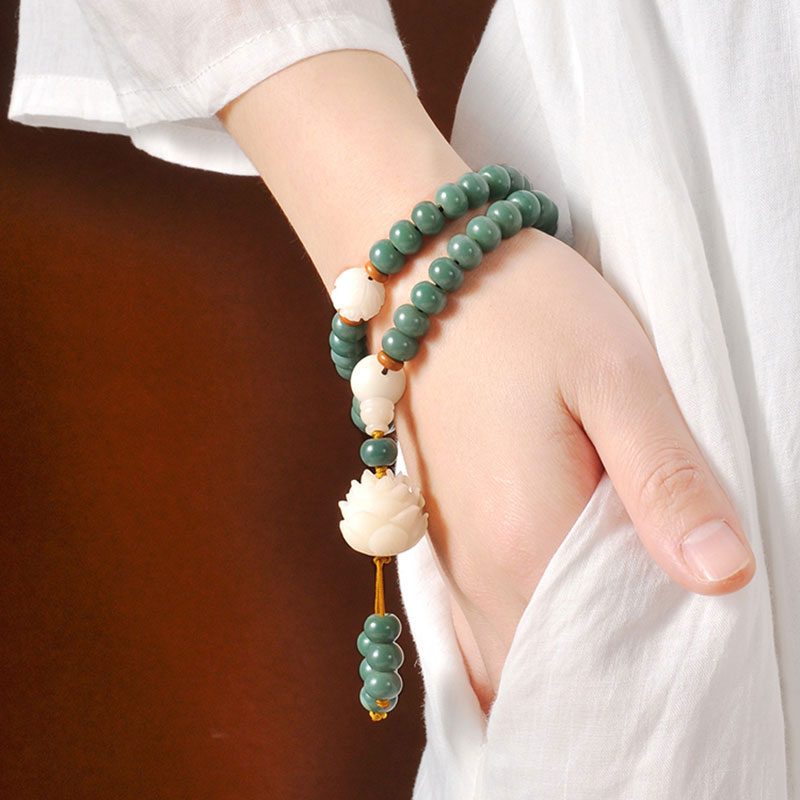 Bodhi Seed Lotus Bracelet – double-wrap bracelet on wrist with carved lotus tassel, bodhi seed