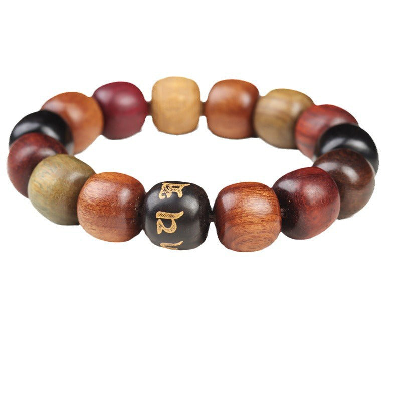 Multi-Wood Stretch Bracelet – barrel beads in ebony and sandalwood with gold Om bead, white background, wood jewelry