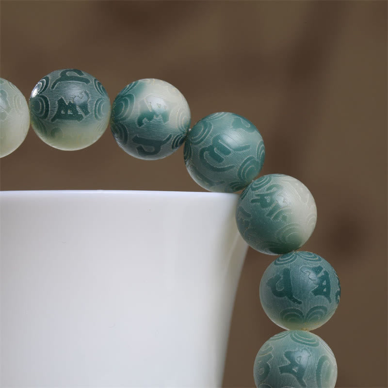 Bodhi Seed Om Mani Padme Hum Bracelet – Beads cascading on white ceramic with Sanskrit carvings, mindfulness bracelet