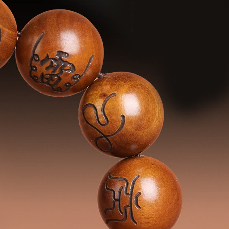 Lightning Struck Jujube Wood Taoist Scripture Bracelet - Close-up of three wood beads with carved talisman characters, wood carving detail