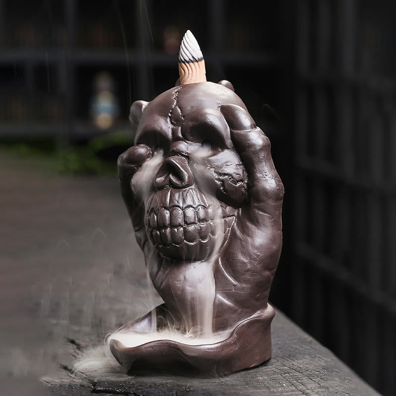 Ghost Hand Incense Burner – side grip with smoke pouring from skull face, backflow incense