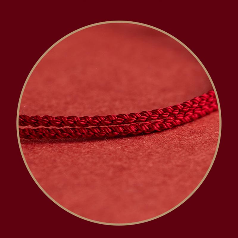Sterling Silver Lotus Peace Buckle Red String Bracelet – Double-strand twisted red cord with kumihimo-style braiding shown in a circular macro crop with gold border