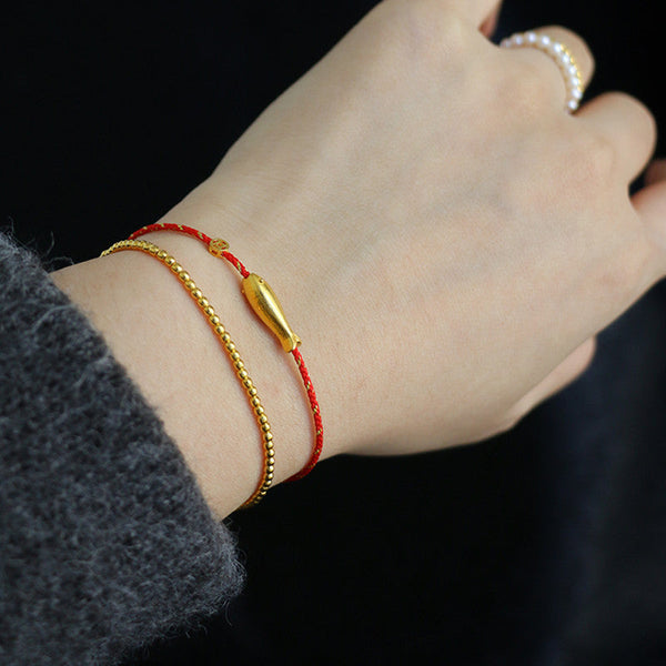 14K Gold Plated Koi Braided Bracelet – macro shot of gold koi scales and eye detail on braided cord bracelet