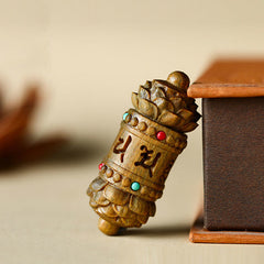 Om Mani Padme Hum Necklace – Carved sandalwood prayer wheel with lotus details and stone inlays on wood box, spiritual