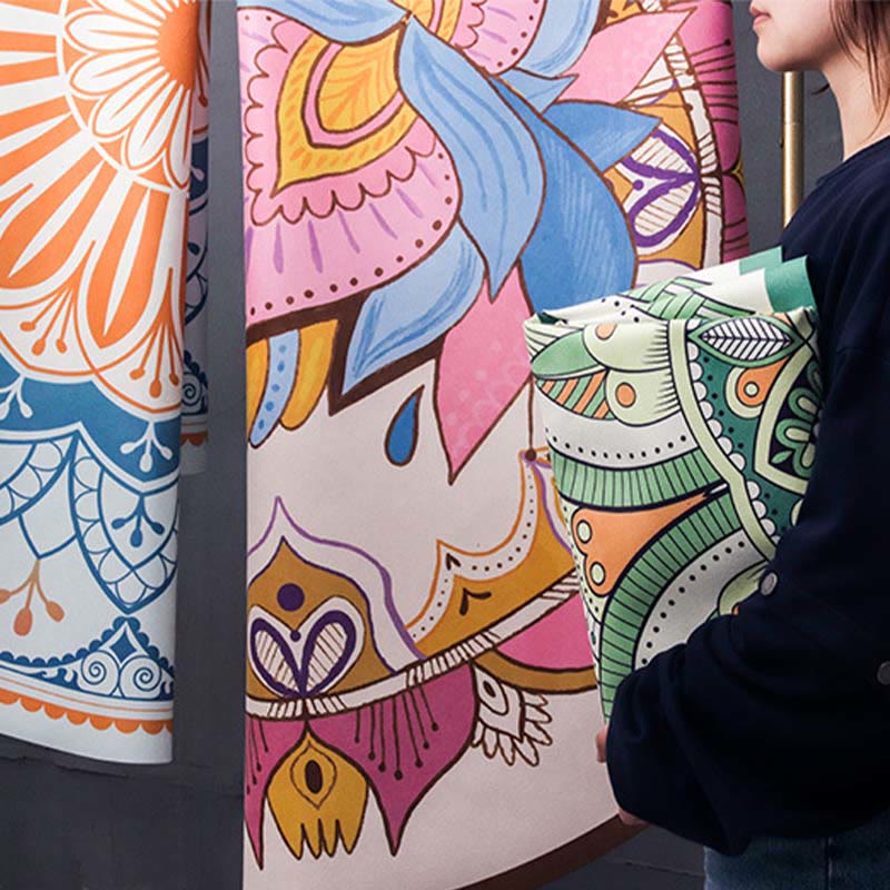 Tibetan Lotus Mandala Yoga Mat two rolled boho rugs with llama and mandala patterns, sage green and pink, showroom display