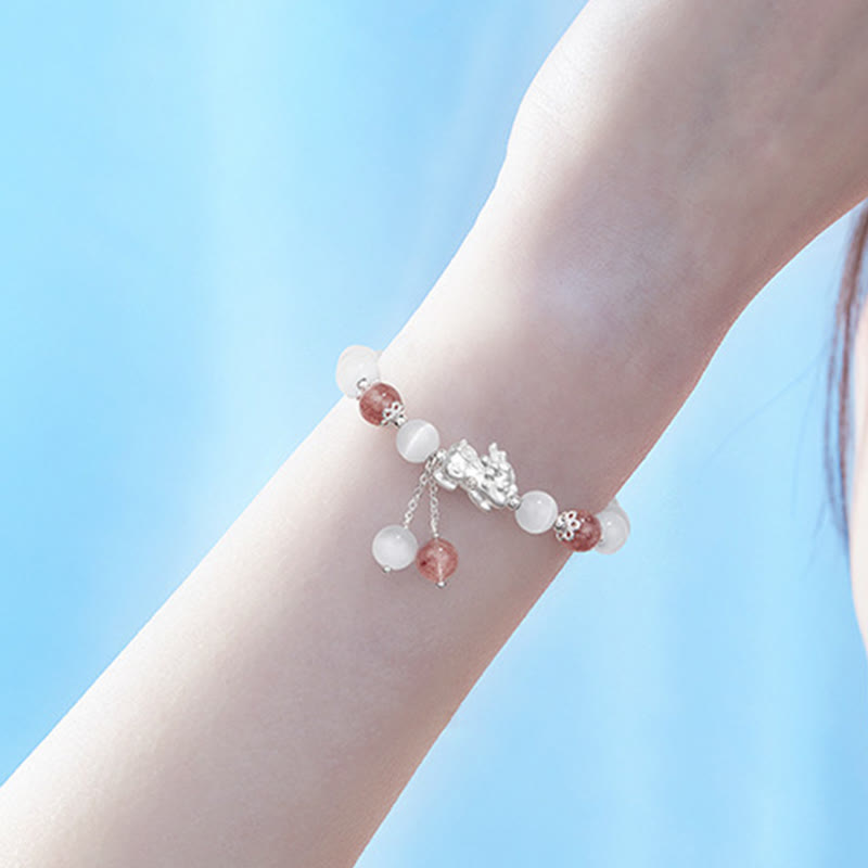 Cat's Eye PiXiu Bracelet – Wrist against blue sky background, airy outdoor jewelry photography