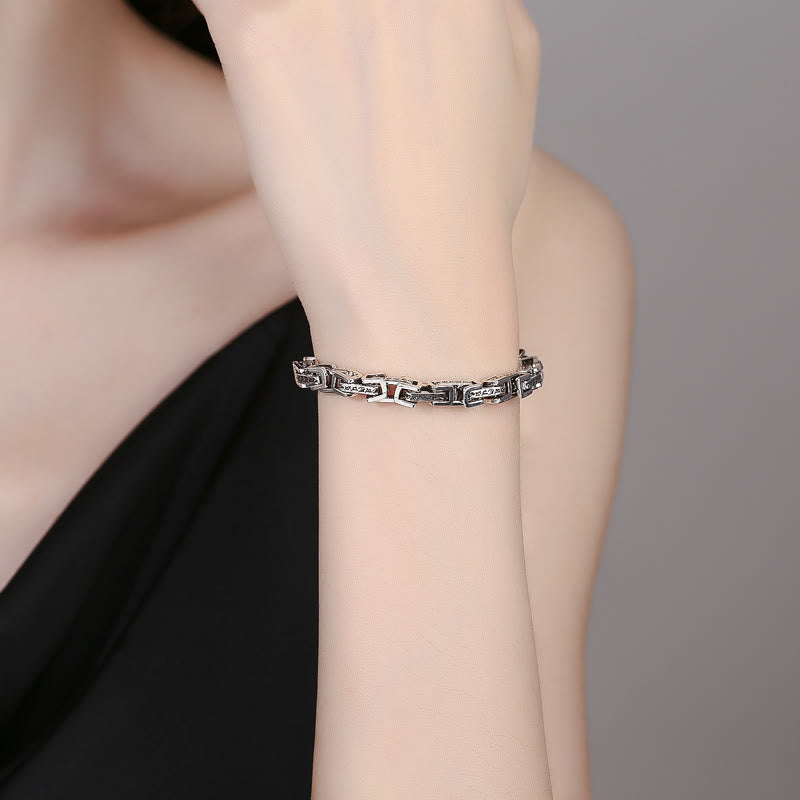 Dragon Om Mani Padme Hum Copper Bracelet - silver-tone copper link bracelet with engraved Om Mani Padme Hum Buddhist mantra details, worn on wrist against neutral gray background, lifestyle fashion shot