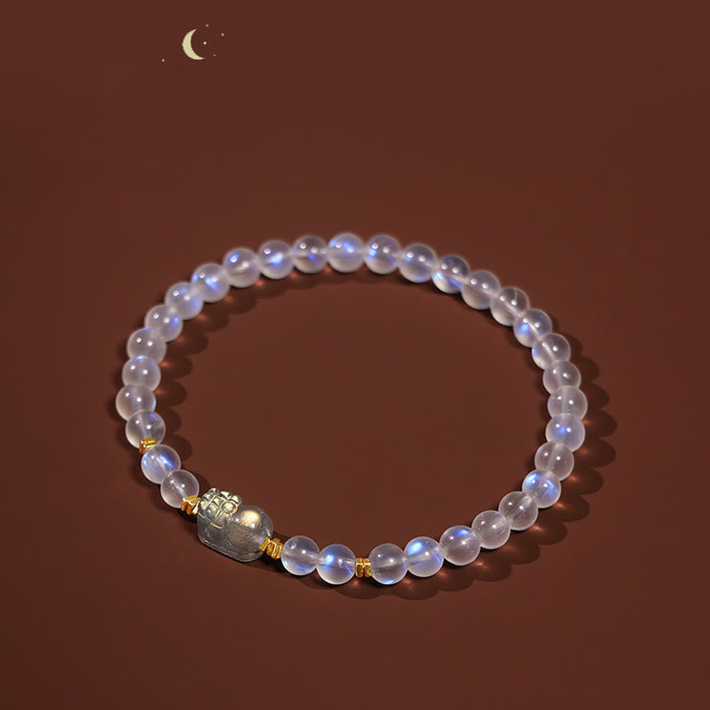 Moonstone PiXiu Bracelet – Moonstone bracelet on warm brown backdrop with crescent moon accent, healing