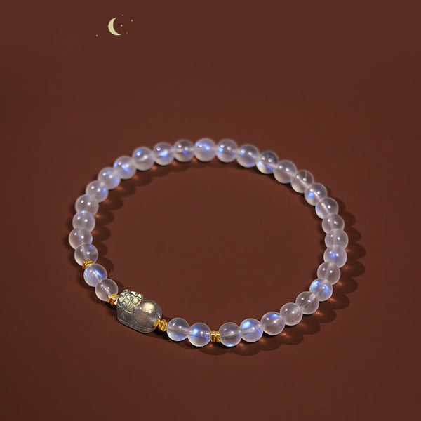 Moonstone PiXiu Bracelet – Moonstone bracelet on warm brown backdrop with crescent moon accent, healing