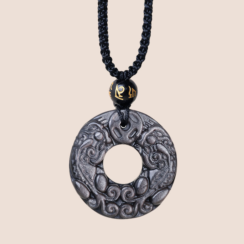Silver Sheen Obsidian Double PiXiu Necklace – Silver sheen obsidian pendant on cream background, feng shui jewelry