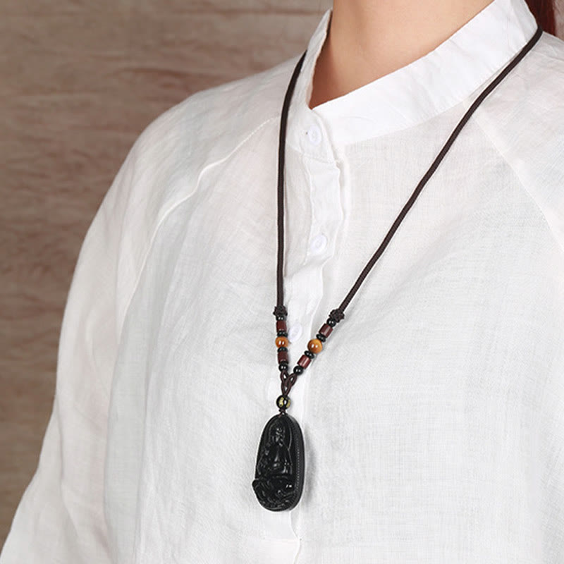 Chinese Zodiac Buddha Black Obsidian Necklace – model in mandarin collar shirt displaying carved Buddha pendant at chest, wearable protection amulet, lifestyle shot
