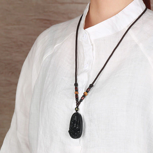 Chinese Zodiac Buddha Black Obsidian Necklace – model in mandarin collar shirt displaying carved Buddha pendant at chest, wearable protection amulet, lifestyle shot