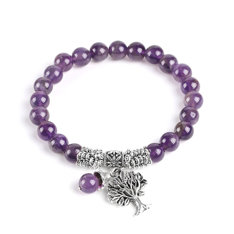 Tree of Life amethyst bracelet with purple gemstone beads, antique silver Tree of Life pendant with branches and roots, silver floral spacers on white background.