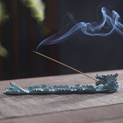Dragon Alloy Incense Burner - Lit incense in bronze dragon on rustic wood, serene