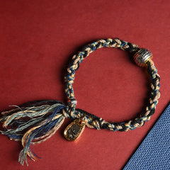 Zakiram Goddess Bracelet – Braided cord with tassel closure on split-tone background, adjustable handmade bracelet