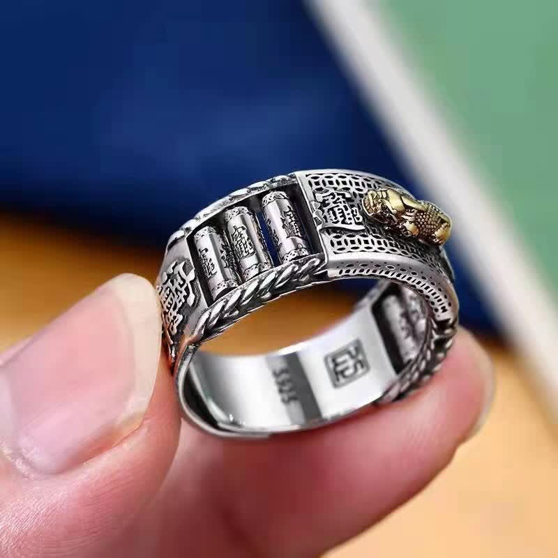 Feng Shui PiXiu Wealth Prayer Wheels Couple Ring – held between fingers showing spinning prayer wheels and gold PiXiu detail, craftsmanship