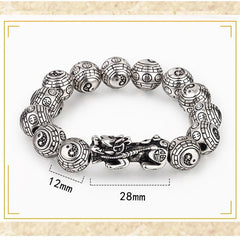 Tibetan Feng Shui PiXiu Silver Bracelet – White background flat lay showing 12mm Bagua beads with 28mm Pixiu centerpiece and coin symbols