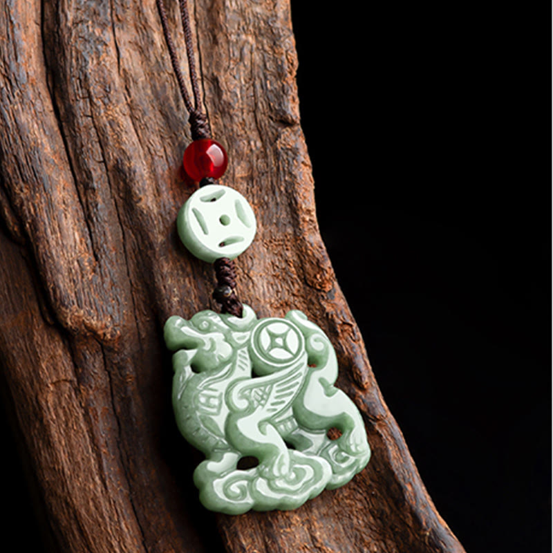 Jade Pixiu Charm – Celadon jade creature on weathered driftwood with black backdrop, feng shui wealth charm