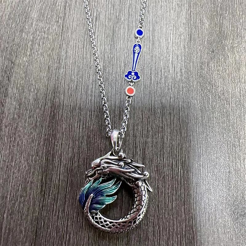 Tibetan Copper Dragon Necklace - Flat-lay showing dragon and enamel chain charms, Symbolic