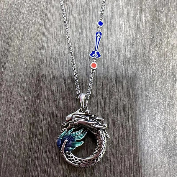 Tibetan Copper Dragon Necklace - Flat-lay showing dragon and enamel chain charms, Symbolic