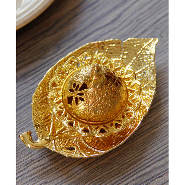 Tibetan Gold Leaf Coaster Incense Burner – Close-up of gold filigree dome lid on leaf-shaped base, ornate metal incense burner