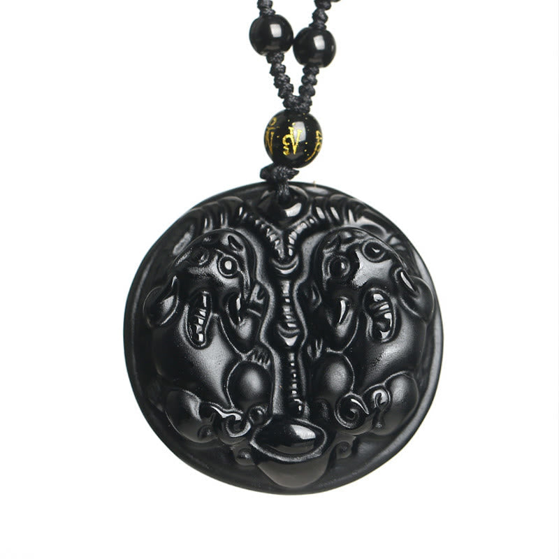 Double PiXiu Necklace – Isolated black obsidian double PiXiu disc pendant on white, purification talisman