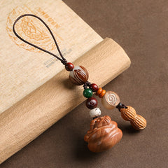 Peach wood Feng Shui phone charm with peanut accent, lotus bead and green agate stone