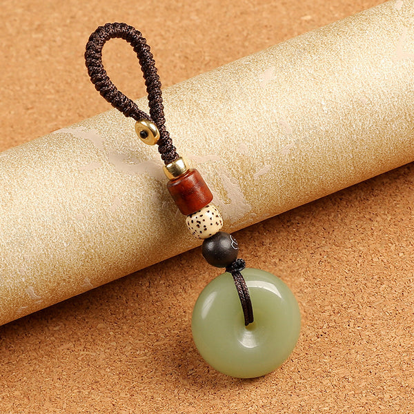 Natural celadon agate ping an kou peace buckle keychain on golden decorative scroll