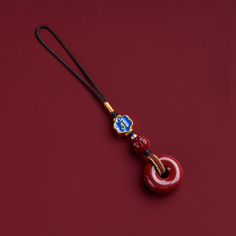 Natural cinnabar zodiac amulet with blue enamel zodiac charm isolated product view Main image