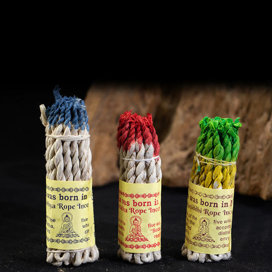 Nepal Rope Incense - three standing bundles in blue red green on dark, meditation