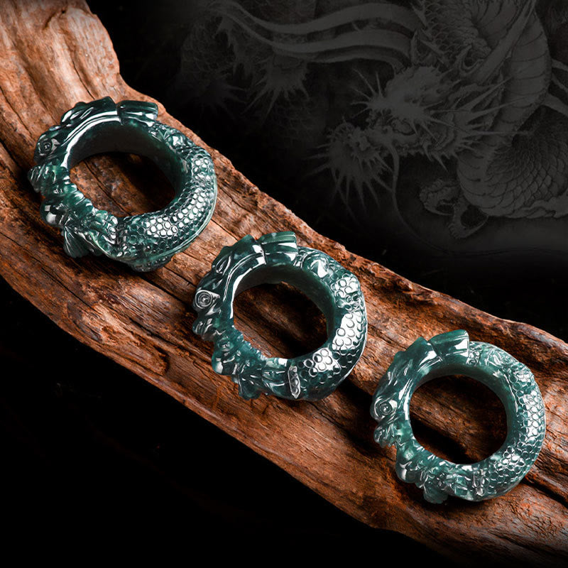 Three Cyan Jade Dragon Rings on wood, multiple sizes, dragon background silhouette, success ring set