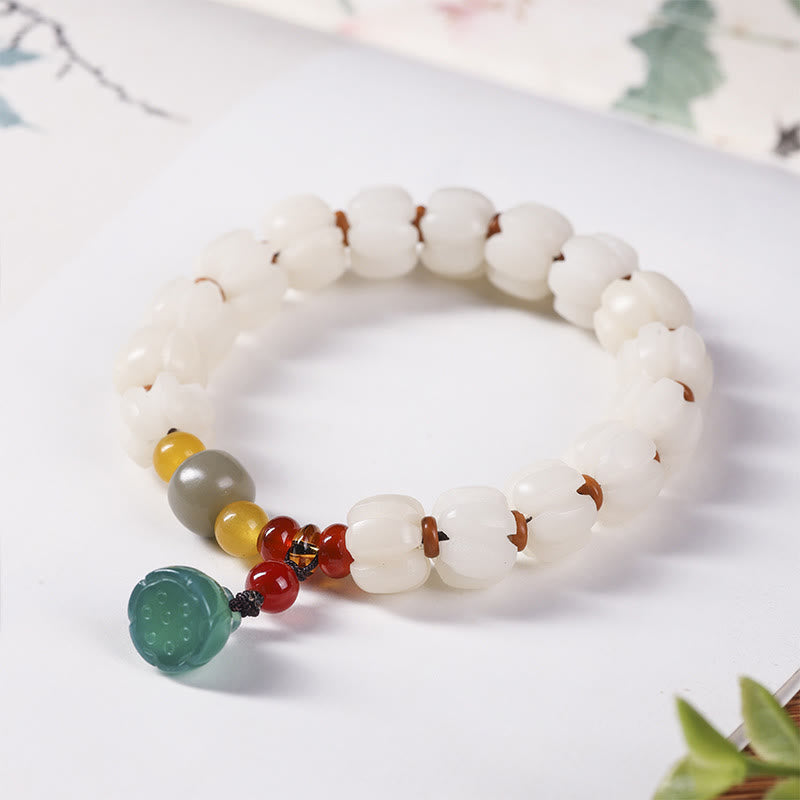 Bodhi Seed Lotus Bead Bracelet - white lotus beads on cream background, natural calm