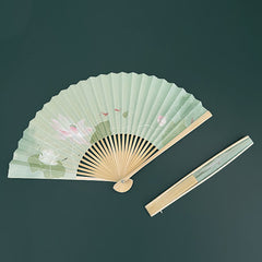 Lotus Koi Fish Folding Fan - fully spread beside slim folded form on dark teal, artistic