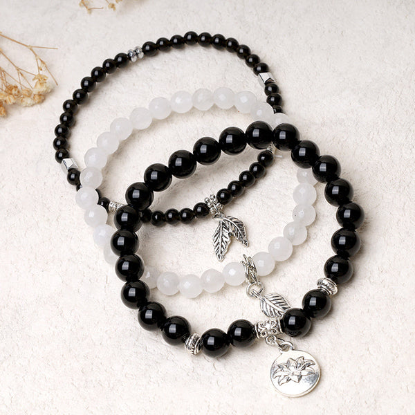 Natural Crystal Bracelet – black and white beaded stack with silver lotus flower medallion, yin-yang bracelet